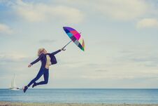 Woman Jumping With Colorful Umbrella On Beach Royalty Free Stock Photography Woman Jumping With Colorful Umbrella On Beach Royalty Free Stock Photography