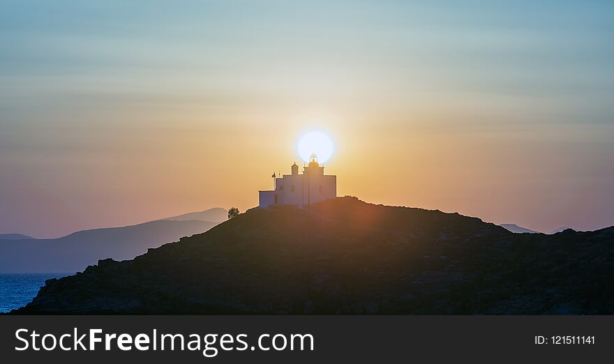 Mediterranean sea. Beautiful sunset and a lighthouse at Kea island, Greece.