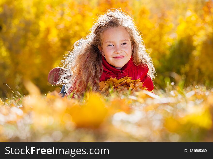 Girl at autumn. Child with leaf at park. Girl at autumn. Child with leaf at park