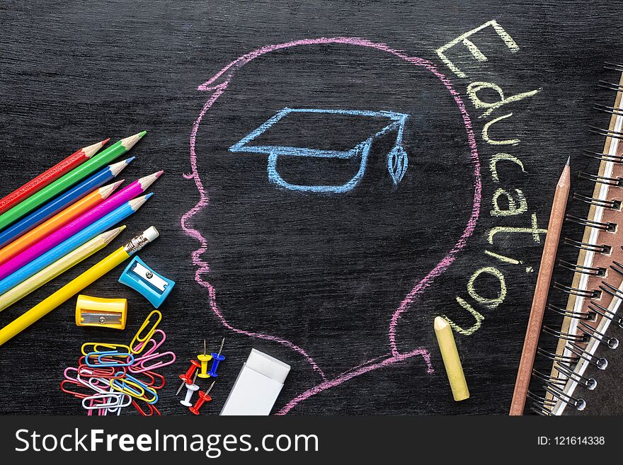 Children`s sketches aimed at success on a chalkboard with chalk and stationary. The concept of intelligence comes from education and back to school.