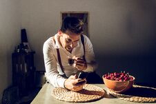 Man Looking At His Cell Phone And Drinking Coffee Royalty Free Stock Image
