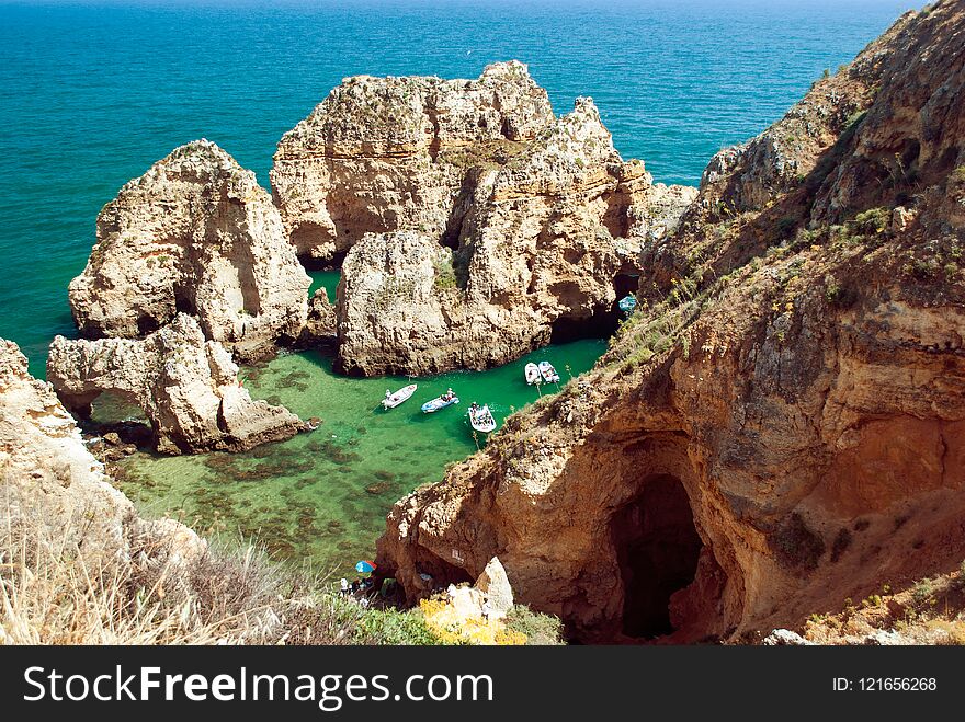 Tourist boats on turquoise sea water at Ponta da Piedade, Algarve region, Portugal