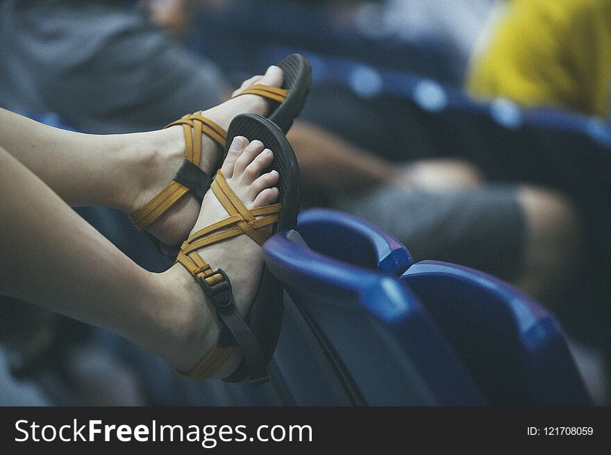 Blue stadium sets and girl legs with brown sandals