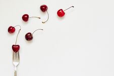 Red Cherry Fruits And Fork On White Background Royalty Free Stock Photos