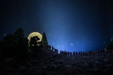 Silhouette Of A Large Crowd Of People In Forest At Night Watching At Rising Big Full Moon. Decorated Background With Night Sky Wit Royalty Free Stock Photos