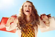 Happy Woman With Shopping Bags Rejoicing Against Blue Sky Royalty Free Stock Photo