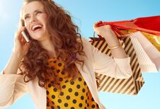 Trendy Woman With Shopping Bags Talking On Mobile Phone Ag Stock Image