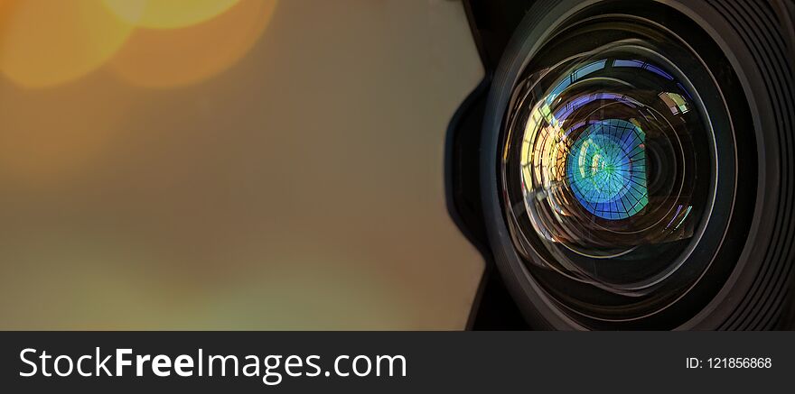 Close up of a large camera lens with bokeh background and copy space .
