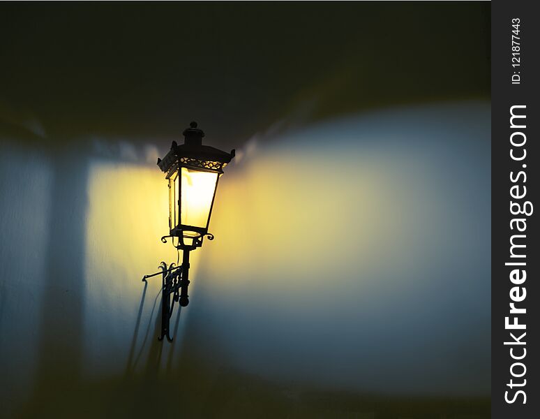 Decorative street lamps. Shadow and light on the wall. Soft focus.