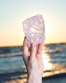 Woman`s Hand Holding Gem Grade Rough Rose Quartz Chunk From Madagascar Stock Images Woman`s Hand Holding Gem Grade Rough Rose Quartz Chunk From Madagascar Stock Images