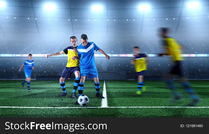 Young soccer players in action on the soccer stadium. Crowd and stadium made in 3D. Young soccer players in action on the soccer stadium. Crowd and stadium made in 3D