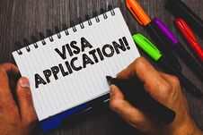 Word Writing Text Visa Application. Business Concept For Form To Ask Permission Travel Or Live In Another Country Hand Holding Pen Stock Image