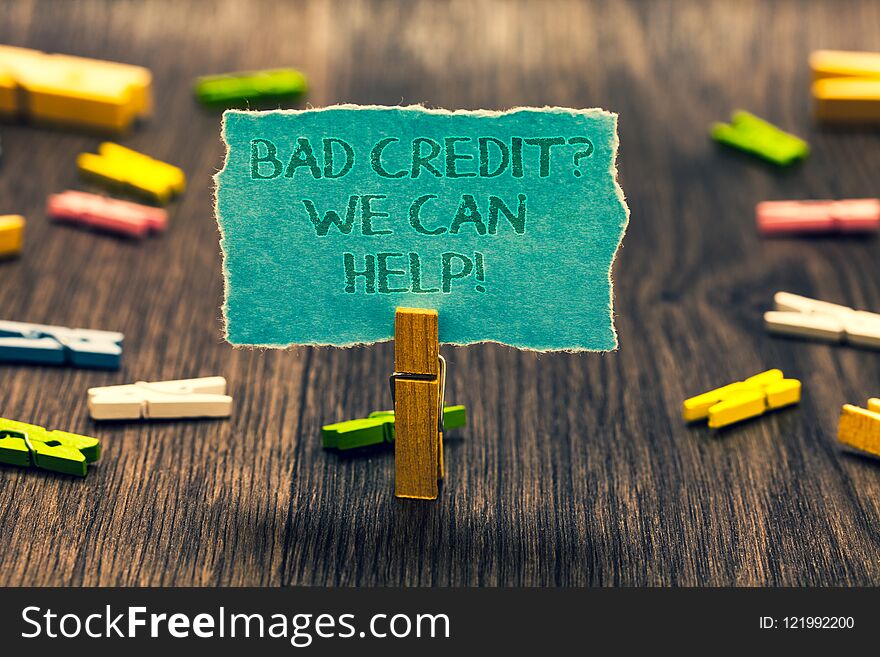 Conceptual hand writing showing Bad Credit question We Can Help. Business photo showcasing Borrower with high risk Debts Financial Paperclip retain blue cardboard blurry woody desk paper clip