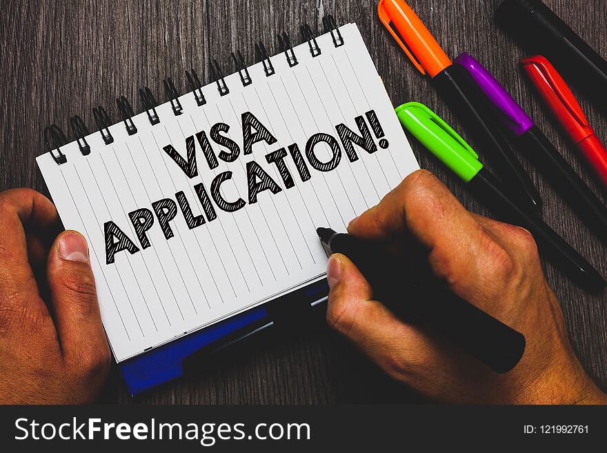 Word writing text Visa Application. Business concept for Form to ask permission travel or live in another country Hand holding pen