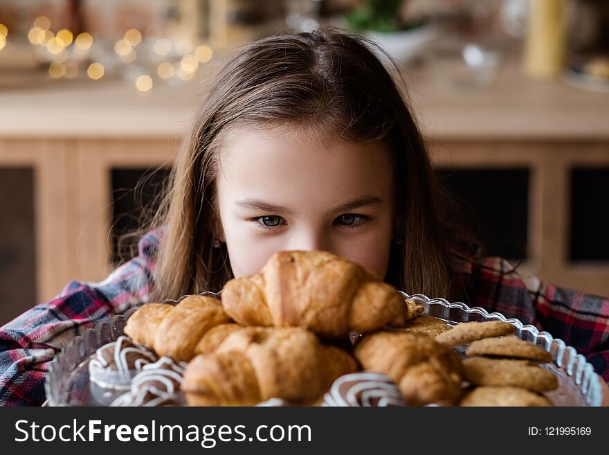 Child nutrition problems. unhealthy eating habits. pastry temptation. little girl is in love with croissants. Child nutrition problems. unhealthy eating habits. pastry temptation. little girl is in love with croissants