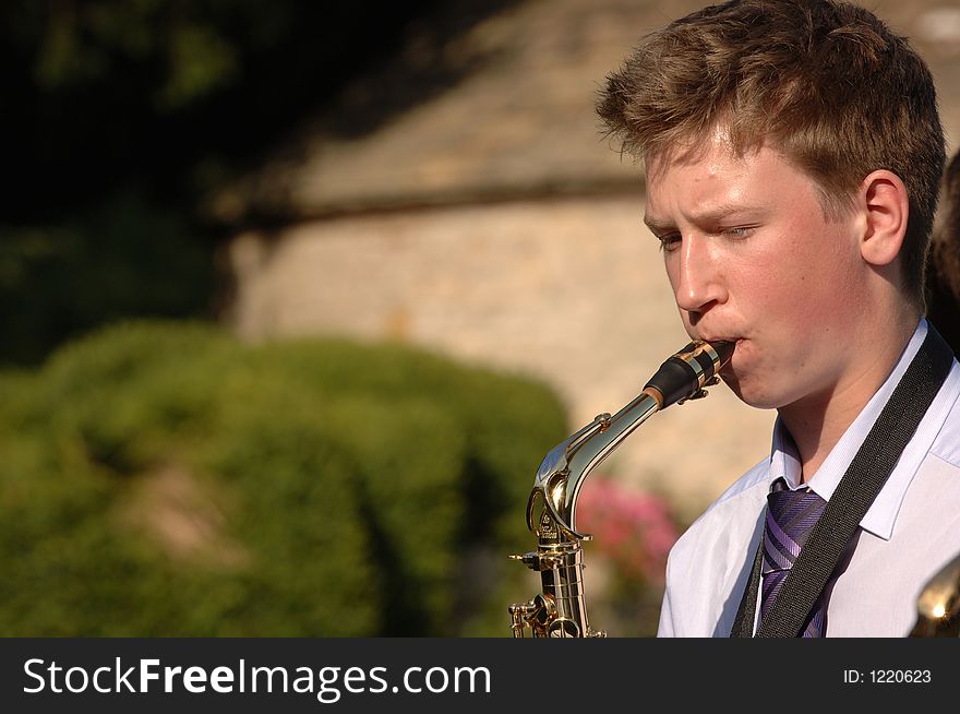 A man playing the saxophone. A man playing the saxophone