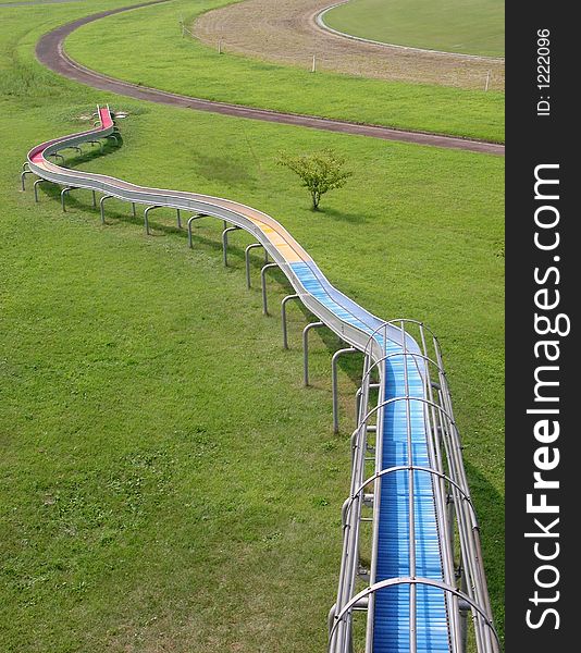 Abstract leisure park lines with a slide, jogging track ,grass field and interesting perspective.