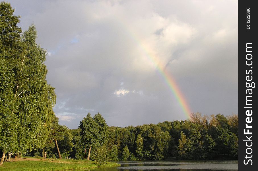 A rainbow over pond in a Moscow park