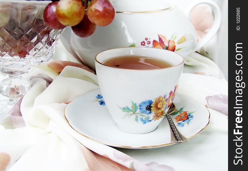 Still life with cup of tea and fruits