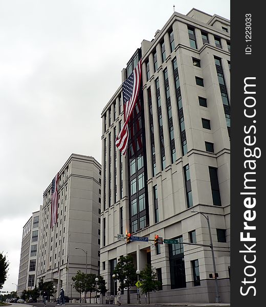 United States flags, hung during a cloudy day, on the front side of buildings in Arlington, VA as a memorial to pay tribute to the victims and heroes of 9-11. United States flags, hung during a cloudy day, on the front side of buildings in Arlington, VA as a memorial to pay tribute to the victims and heroes of 9-11.