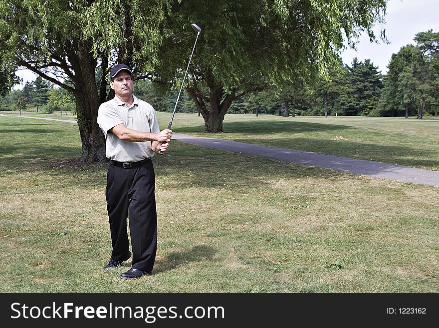 Man studies the lie of his last golf drive. Man studies the lie of his last golf drive.