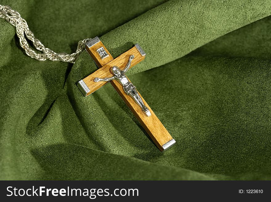Photo of a Wooden Crucifix on a Green Velvet Background