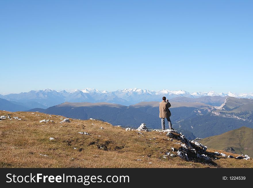 Man takes photo of breathtaking view,Dolomites,italy. Man takes photo of breathtaking view,Dolomites,italy
