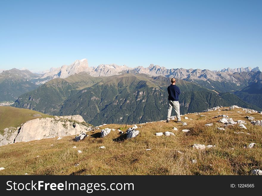 Man takes stock of breathtaking view,Dolomites,Italy. Man takes stock of breathtaking view,Dolomites,Italy