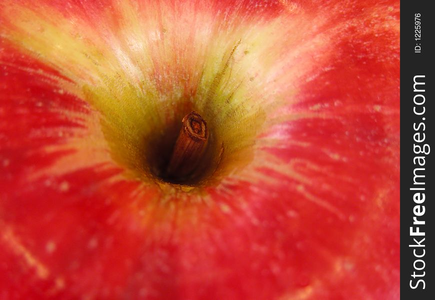 Extreme close-up of the upper part of an apple with stalk. Selective focus and intended highlights. Extreme close-up of the upper part of an apple with stalk. Selective focus and intended highlights.