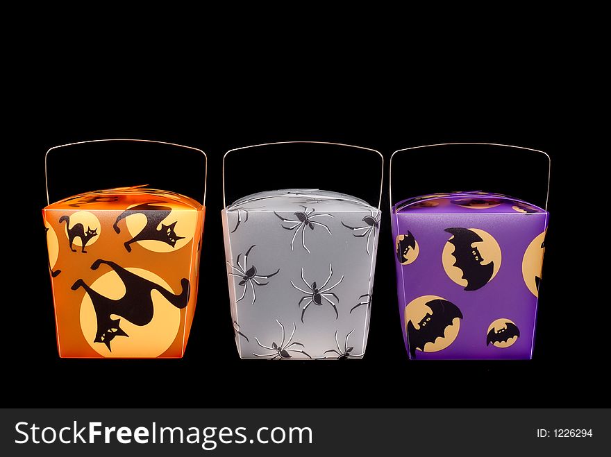 Colorful halloween candy carriers on black