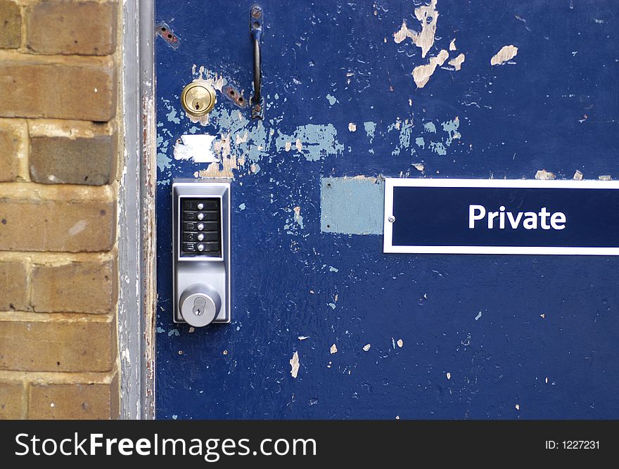 A battered door is locked and secured with a key and combination lock. A battered door is locked and secured with a key and combination lock