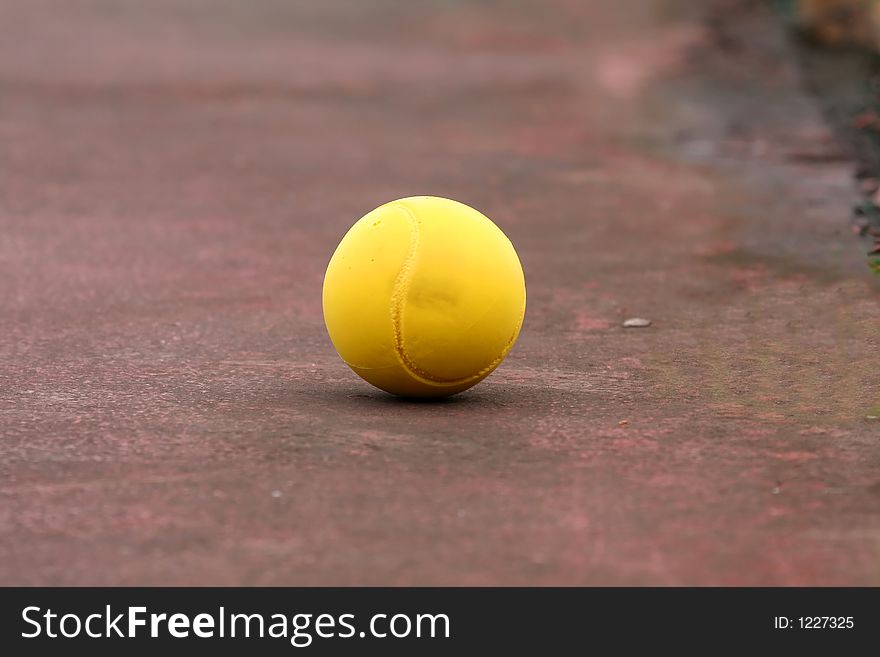 Yellow ball on a red ground