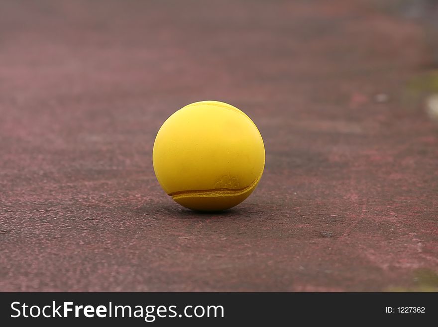 Yellow tennis ball on the court