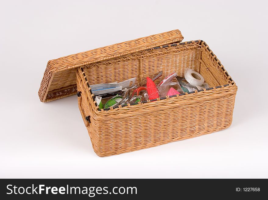 Isolated Wicker Sewing Basket Filled with Supplies