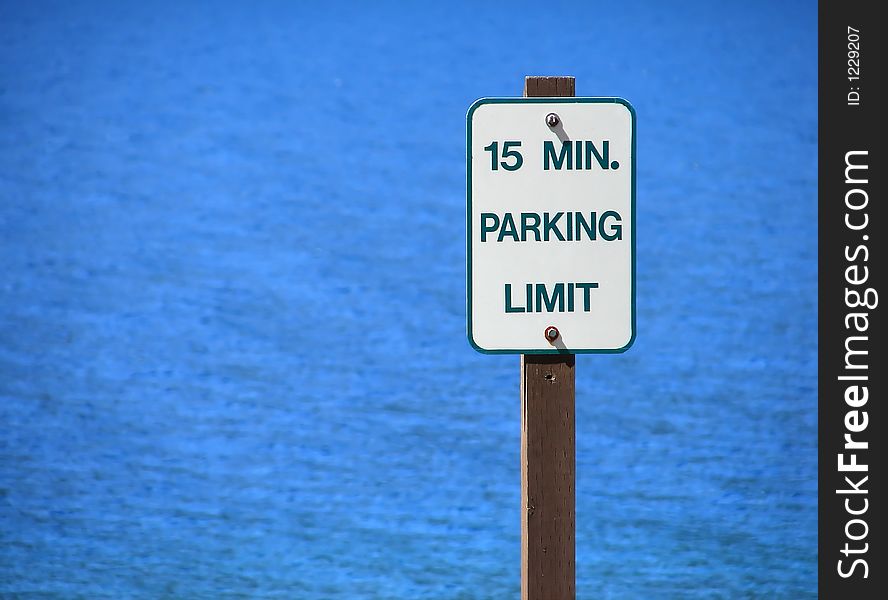 Parking sign in front of a beautiful lake.