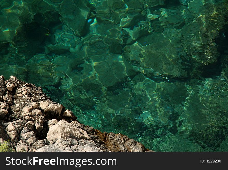 Pure sea water and a rock