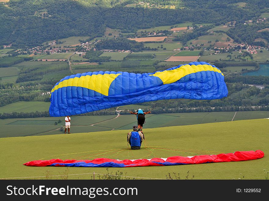Paraglider taking off from a cliff. Paraglider taking off from a cliff