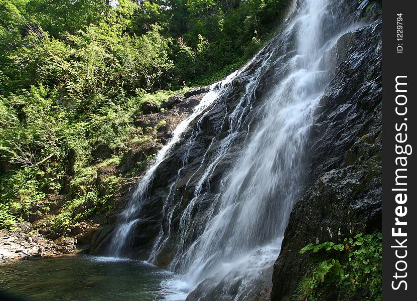 The cascade du pissou near fond-de-france in the belledonne mountain in  the french alps. The cascade du pissou near fond-de-france in the belledonne mountain in  the french alps