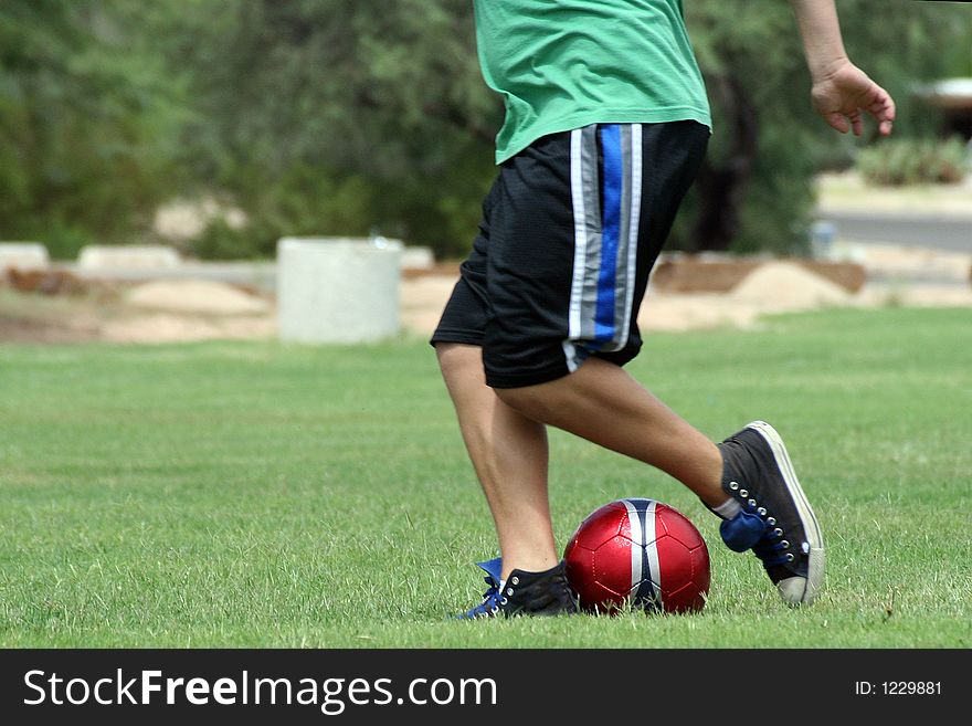 Man kicking a soccer ball. Man kicking a soccer ball.