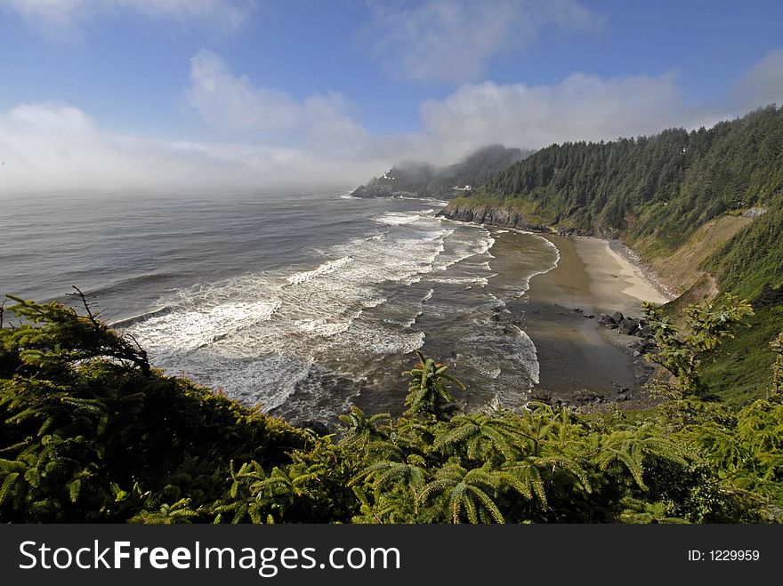 The beacon of the Heceta Head lighthouse seen from a distance along the Oregon coast. The beacon of the Heceta Head lighthouse seen from a distance along the Oregon coast