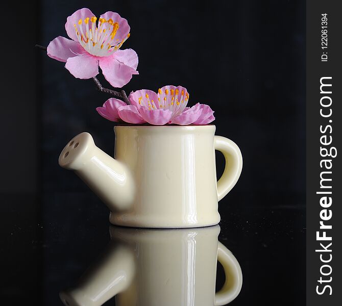 Gardening watering can ornament, with cherry blossoms inside