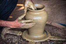 Closeup Of Potter`s Hands Making Clay Water Pot On Pottery Wheel. Royalty Free Stock Photography