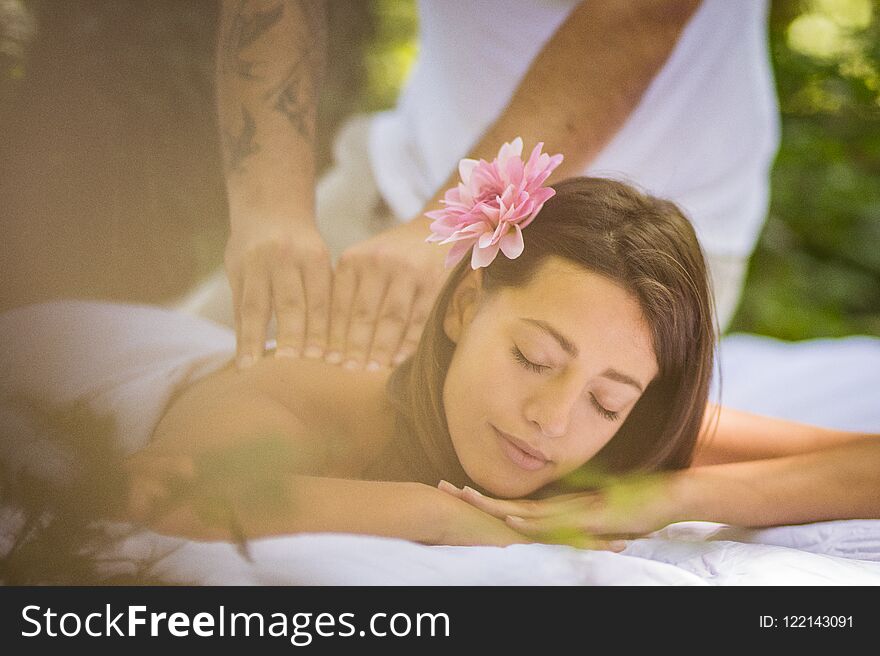 Image of brunette women enjoy in massage at nature. Close up.