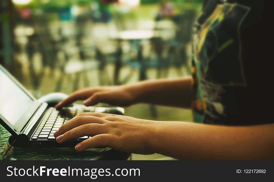 Scene from an outdoor restaurant, young girl with lap top. Scene from an outdoor restaurant, young girl with lap top.