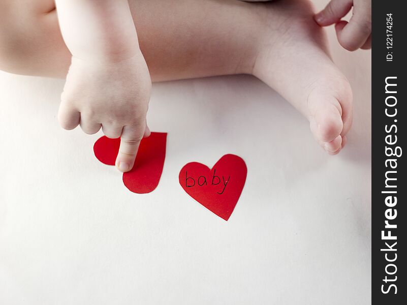Handle and a baby`s leg and a red heart small
