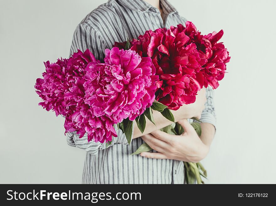 Portrait Of Woman Holding Bouquet Of Violet And Purple Flowers