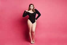 Plus Size Model Girl, Fashionable Blonde In Black Bodysuit, With Bright Makeup And With Stylish Hairstyle, Smiling And Posing Stock Images Plus Size Model Girl, Fashionable Blonde In Black Bodysuit, With Bright Makeup And With Stylish Hairstyle, Smiling And Posing Stock Images