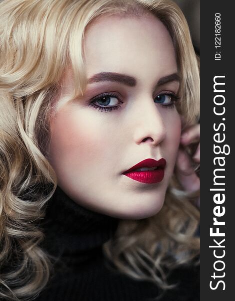 Portrait of elegant blond retro woman with beautiful velvet red lips, she touches her face. Portrait of elegant blond retro woman with beautiful velvet red lips, she touches her face.