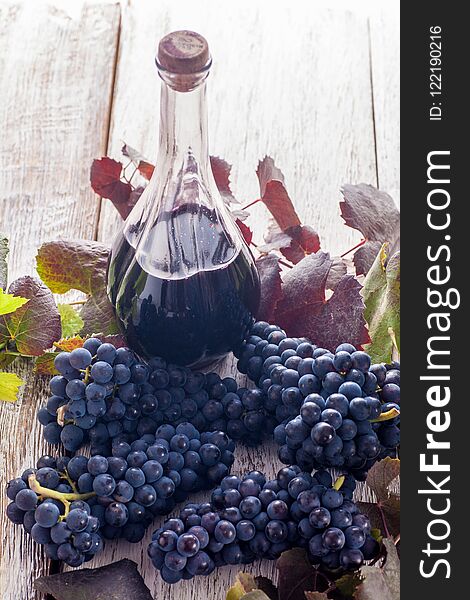 Grapes with wine on wooden table. Rustic style. Grapes with wine on wooden table. Rustic style.