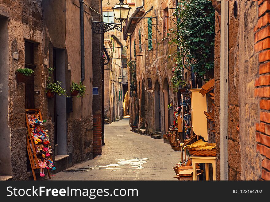 Narrow street of medieval ancient tuff city Pitigliano, travel Italy background. Narrow street of medieval ancient tuff city Pitigliano, travel Italy background